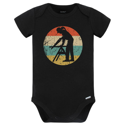 Retro Female Carpenter Sawing Vintage Style Carpentry Baby Bodysuit (Black)
