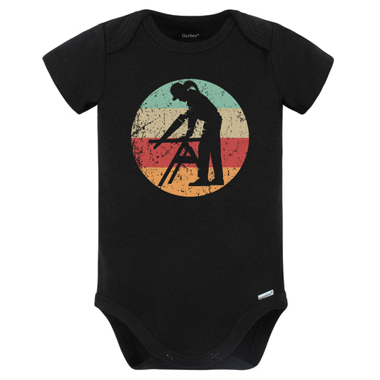 Retro Female Carpenter Sawing Vintage Style Carpentry Baby Bodysuit (Black)