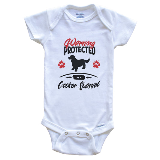 Warning Protected By A Cocker Spaniel Funny Dog Owner Baby Bodysuit