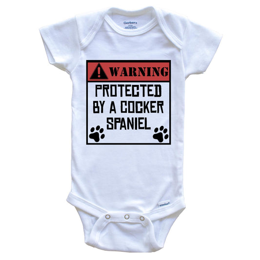 Warning Protected By A Cocker Spaniel Funny Baby Onesie