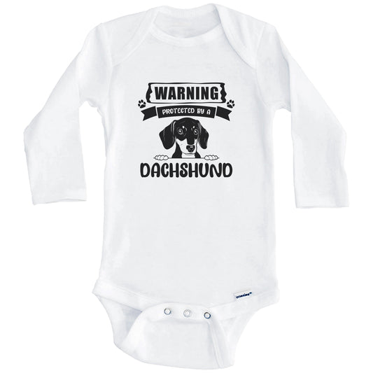 Warning Protected By A Dachshund Funny Cute Dog Breed Baby Bodysuit (Long Sleeves)